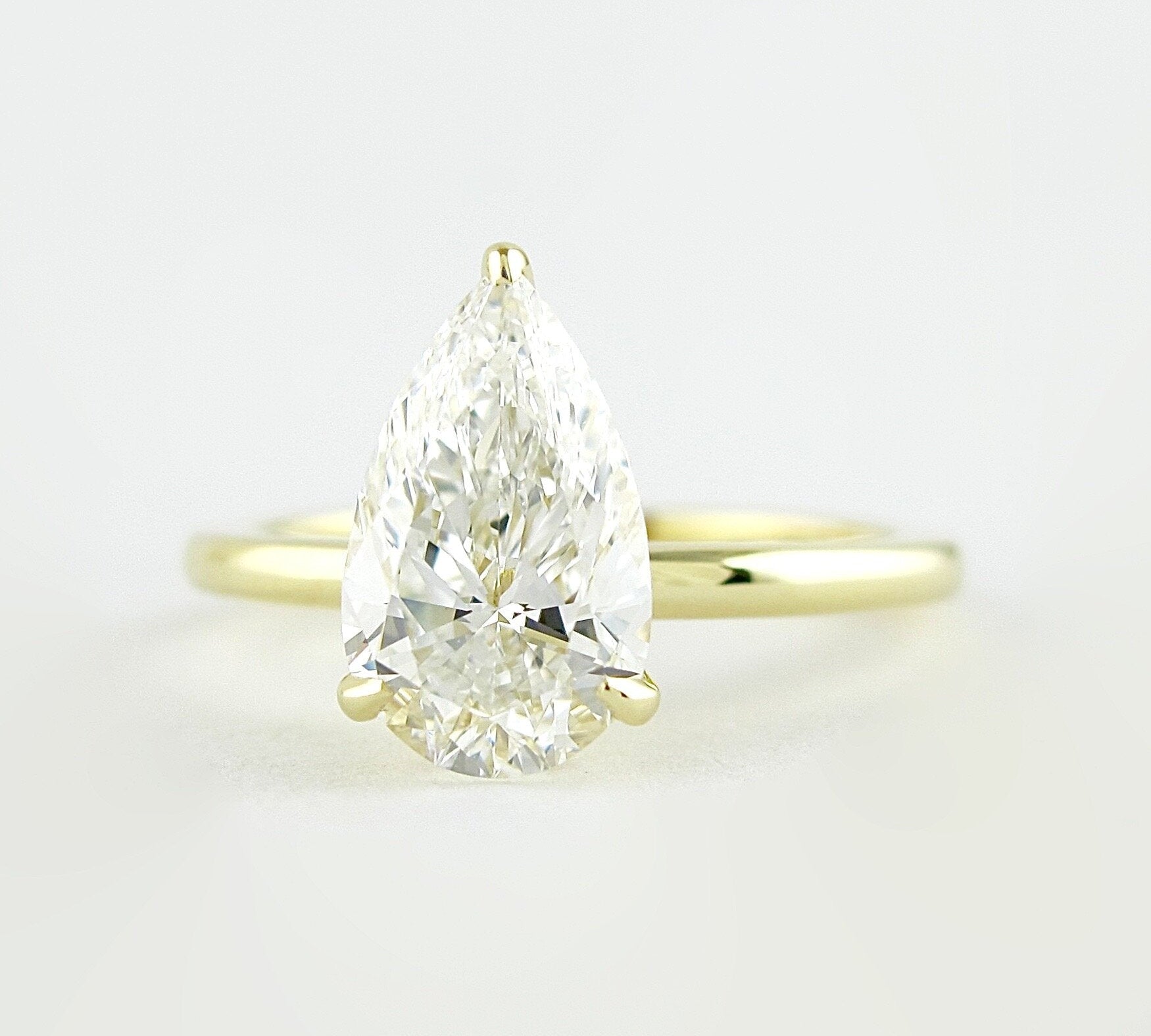 1.5 CT Pear Cut Solitaire Style Moissanite Engagement Ring 1