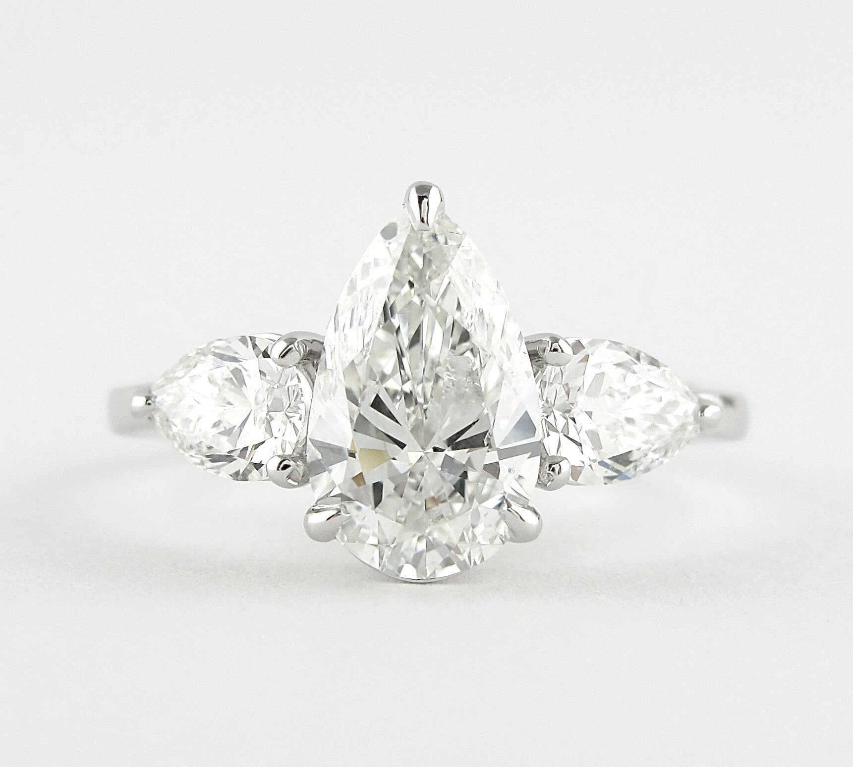 1.50 CT Pear Cut Three Stone Style Moissanite Engagement Ring 1