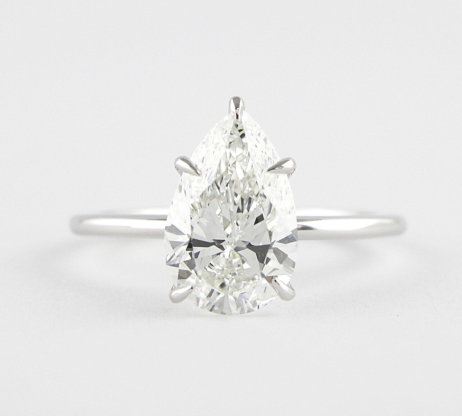 1.5 CT Pear Cut Solitaire Style Moissanite Engagement Ring 1
